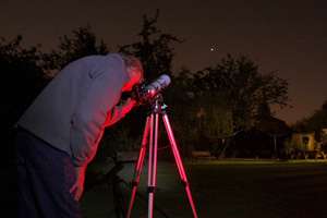 Observer using small telescope.